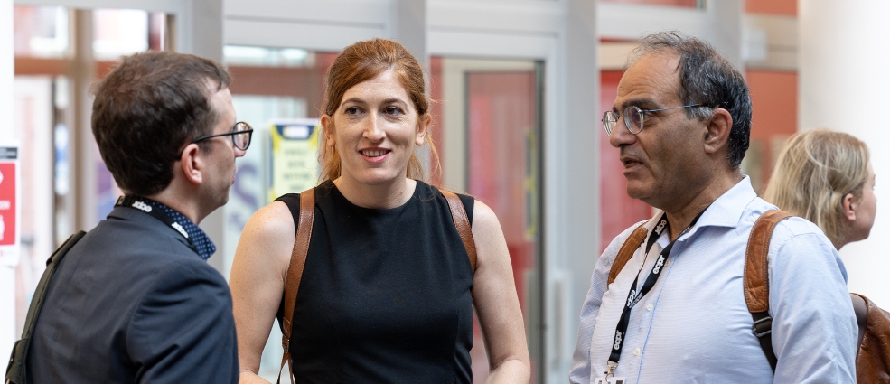 Three individuals talking to each other at the Regulatory Governance Conference 2023 in Antwerp